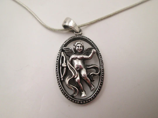 Cupid openwork oval pendant with cord. 925 sterling silver. Carabiner clasp. 1980's. Europe
