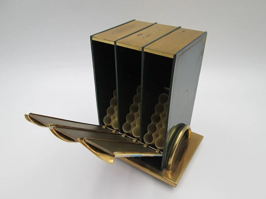 Dispensador de cigarrillos con forma de libro y base. Latón lacado a color. Italia. 1950
