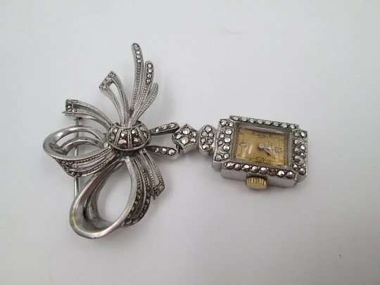 Dulux women's pendant watch. Rhodium plated metal. Sterling silver brooch. 1940's