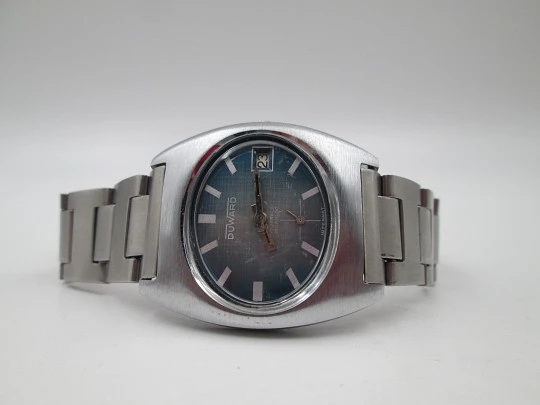 Duward Internat reloj unisex. Metal niquelado y acero. Dial azul. Calendario. Brazalete. 1970