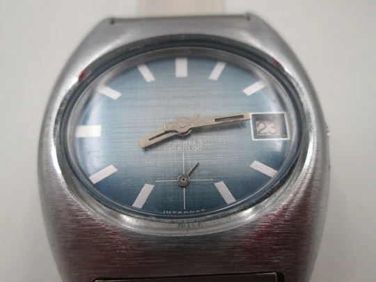 Duward Internat reloj unisex. Metal niquelado y acero. Dial azul. Calendario. Brazalete. 1970