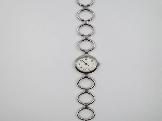 Ema. Acero / metal cromado. Cuerda manual. Suiza. Brazalete calado. Mujer