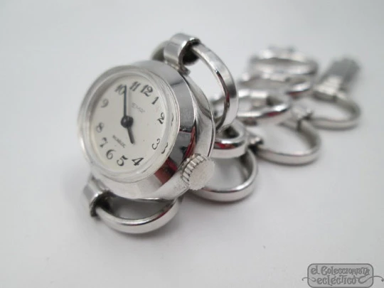 Ema. Acero / metal cromado. Cuerda manual. Suiza. Brazalete calado. Mujer