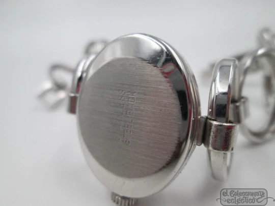 Ema. Acero / metal cromado. Cuerda manual. Suiza. Brazalete calado. Mujer