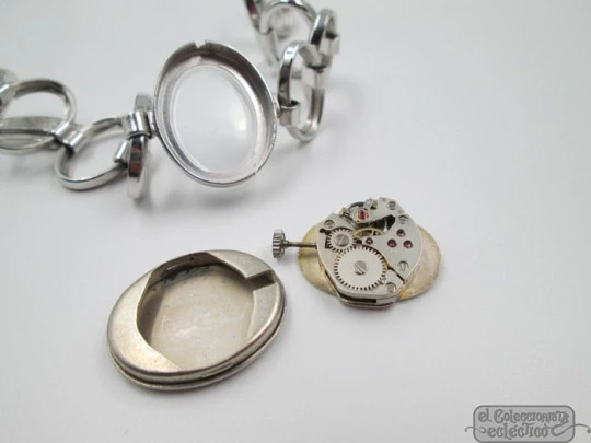 Ema. Acero / metal cromado. Cuerda manual. Suiza. Brazalete calado. Mujer