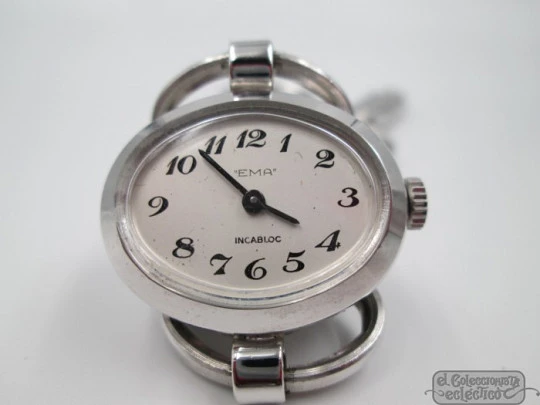 Ema. Acero / metal cromado. Cuerda manual. Suiza. Brazalete calado. Mujer