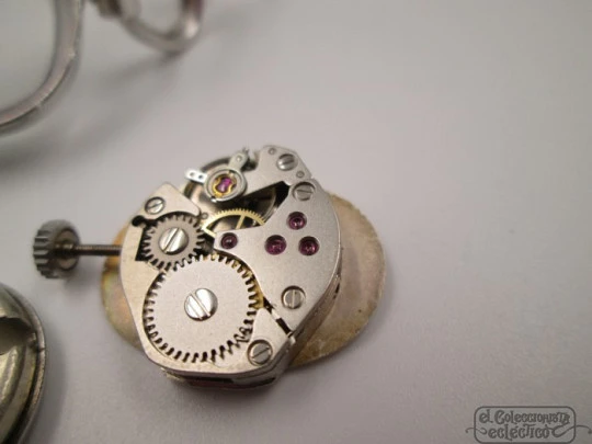 Ema. Acero / metal cromado. Cuerda manual. Suiza. Brazalete calado. Mujer