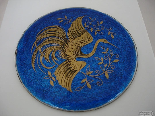 Enamel on copper. Circular shape. Gold crane bird. Blue background
