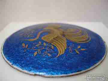 Enamel on copper. Circular shape. Gold crane bird. Blue background