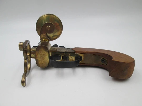 Encendedor de yesca con forma de pistola y portavela. Hierro, latón y madera. Italia, 1960 Encendedor de yesca con forma de pistola y portavela. Hierro, latón y madera. Italia, 1960