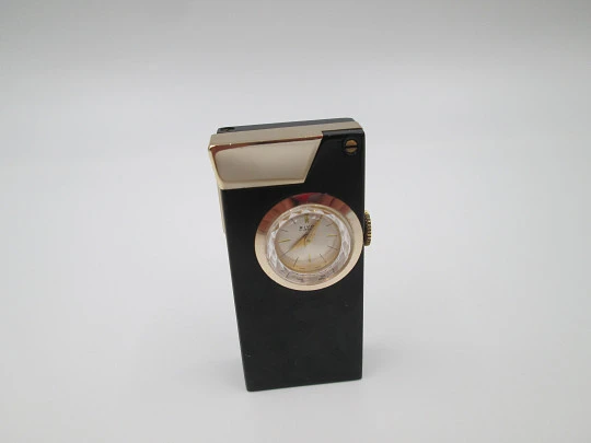 Encendedor gasolina / reloj mecánico Rivo. Metal lacado negro y chapado oro. Suiza. 1960