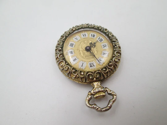 Exactus pendant watch. Gold plated. Manual wind. Romantic scene enamel on back. 1970's Exactus pendant watch. Gold plated. Manual wind. Romantic scene enamel on back. 1970's