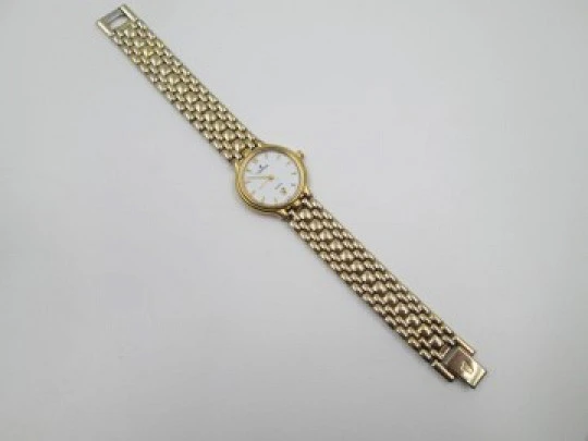 Festina mujer. Acero inoxidable y chapado oro. Cuarzo. Brazalete. Dial blanco. 1990