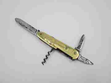 Figurative pocket knife. Brass and steel. Embossed bagpiper and woman. 1930's