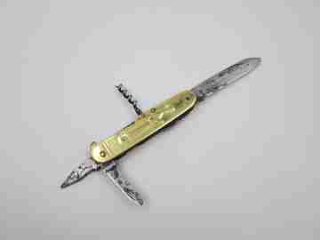 Figurative pocket knife. Brass and steel. Embossed bagpiper and woman. 1930's