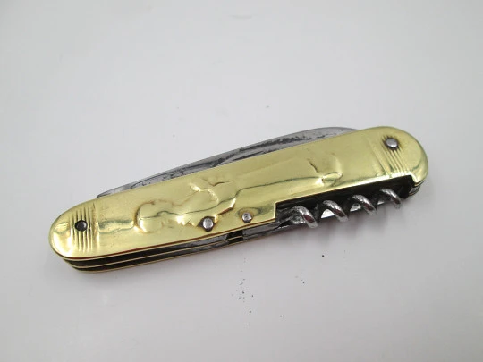 Figurative pocket knife. Brass and steel. Embossed bagpiper and woman. 1930's