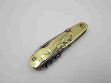 Figurative pocket knife. Brass and steel. Embossed bagpiper and woman. 1930's