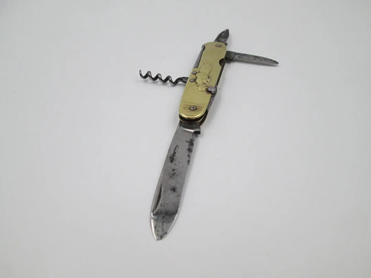 Figurative pocket knife. Brass and steel. Embossed bagpiper and woman. 1930's