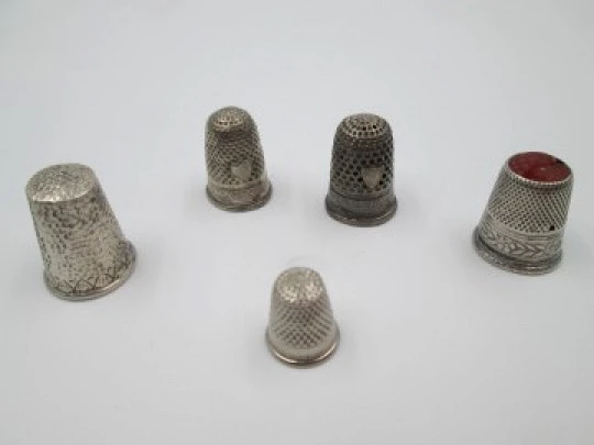 Five sewing thimbles. Sterling silver. Hammer texture & ornate motifs