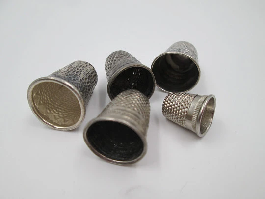 Five sewing thimbles. Sterling silver. Hammer texture & ornate motifs