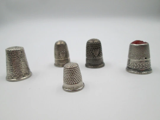 Five sewing thimbles. Sterling silver. Hammer texture & ornate motifs