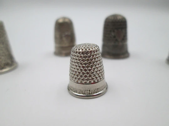 Five sewing thimbles. Sterling silver. Hammer texture & ornate motifs