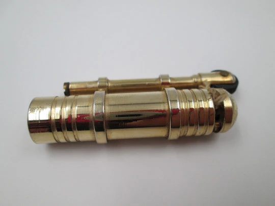 Flint wheel & wick cigarette lighter. Gold plated metal. Tubular shape. 1980's