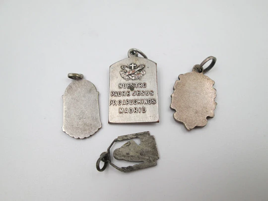 Four religious medals. Silver plated metal. Jesus Christ and Virgin. Spain. 1930's