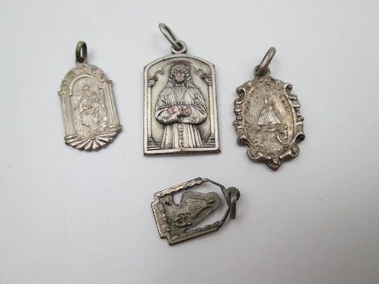Four religious medals. Silver plated metal. Jesus Christ and Virgin. Spain. 1930's