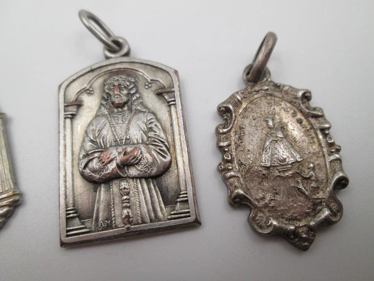 Four religious medals. Silver plated metal. Jesus Christ and Virgin. Spain. 1930's