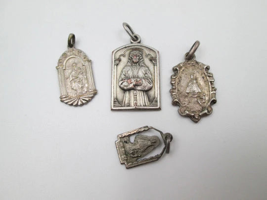 Four religious medals. Silver plated metal. Jesus Christ and Virgin. Spain. 1930's