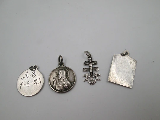 Four religious medals. Sterling silver. Christ, cross, virgin and saint. Spain. 1925-1970's Four religious medals. Sterling silver. Christ, cross, virgin and saint. Spain. 1925-1970's