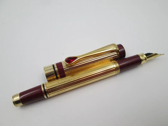 Genius / Peruzzo. Gold plated metal & burgundy resin. Swarovski crystal. Italy. 2000's