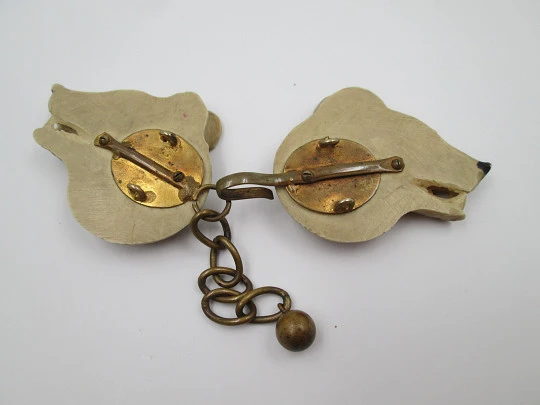 Gentleman's cape / cloak clasp. Grey resin and golden metal. Wolves heads. Europe. 1950's