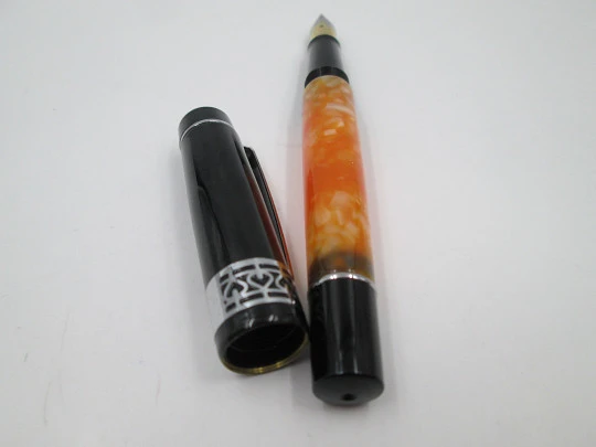 German fountain pen. Orange and black pearl resin. Silver plated details. Golden nib. 2005's