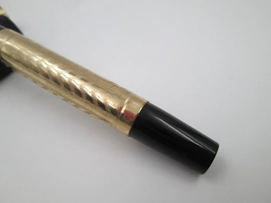 Hard rubber and 14k gold filled fountain pen. Lever filler. Guilloche. 1920's