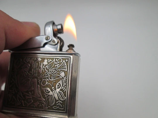 Ibelo Monopol pocket petrol lighter. Silver plated. Flautist motif. Germany. 1950's
