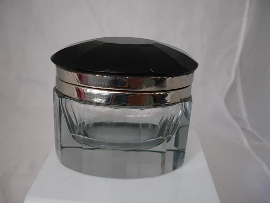 Inkwell. Faceted glass. Oval shape. Black cap. Silver metal. 1940's