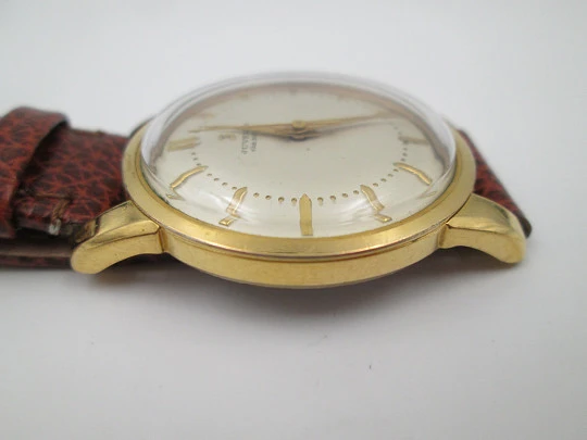 Juvenia. Chapado oro 20 micras y acero inoxidable. Cuerda manual. Correa. 1950. Suiza