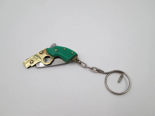 Keychain gun shape pocket knife. Steel, gold plated metal and green resin. 1980's. Spain