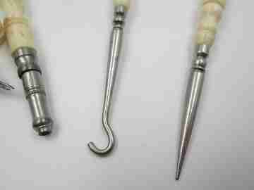 Ladies travel set. Buttons hook, awl, pencil & refills box. Ribbed bone and metal. 1930's