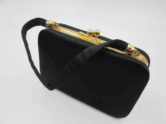 Ladie's vanity bag with top handle. Black silk and gold plated metal. Balls clasp. 1960's