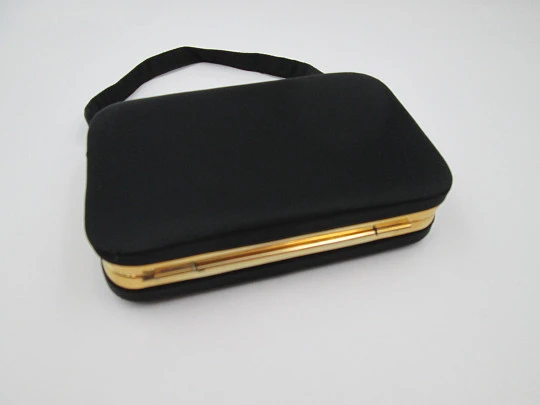 Ladie's vanity bag with top handle. Black silk and gold plated metal. Balls clasp. 1960's