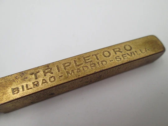Lapicero publicitario Tripletoro. Metal dorado. Metro lateral. España. 1940