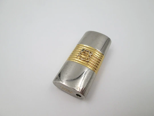 Loewe lighter cover. Silver and gold plated metal. Brand logo. Spain. 2010