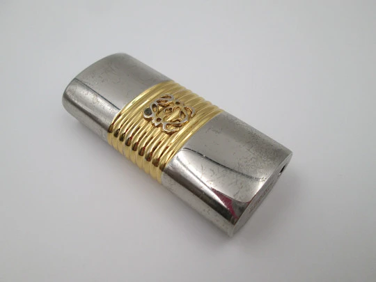 Loewe lighter cover. Silver and gold plated metal. Brand logo. Spain. 2010