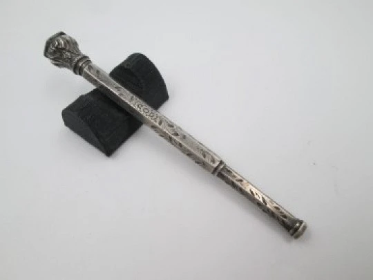 Mechanical propelling twist pencil. Chiselled silver and amber stone. 1900's