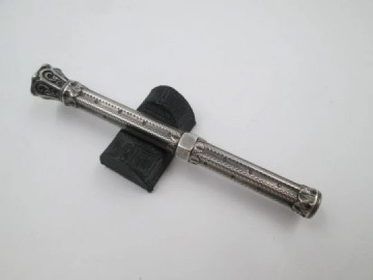 Mechanical propelling twist pencil. Chiselled silver and amber stone. 1900's