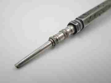 Mechanical propelling twist pencil. Chiselled silver and amber stone. 1900's