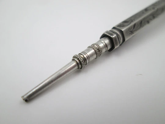 Mechanical propelling twist pencil. Chiselled silver and amber stone. 1900's